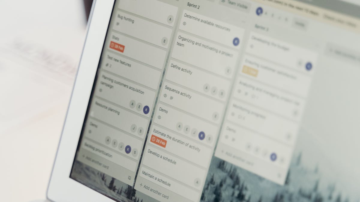 Laptop screen showing project management and workflow software, representing intelligent process automation