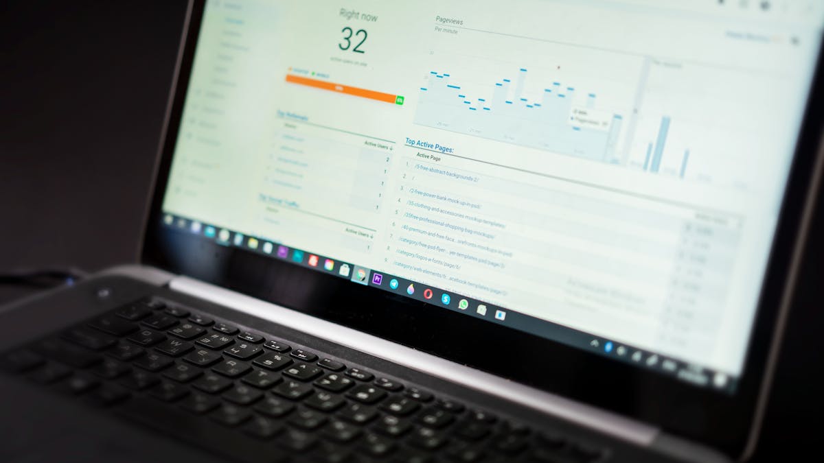 Laptop showing a real-time analytics dashboard with charts, representing AI-driven business transformation